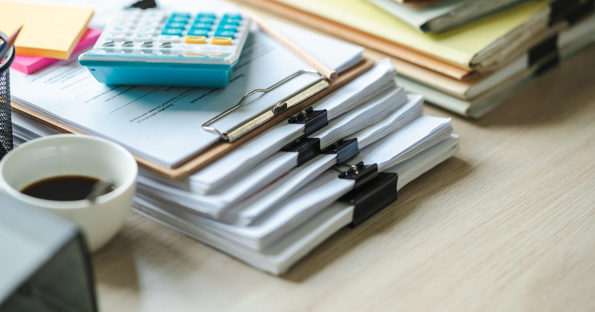 Cost of a bad hire shown by a financial report and calculator on an office desk