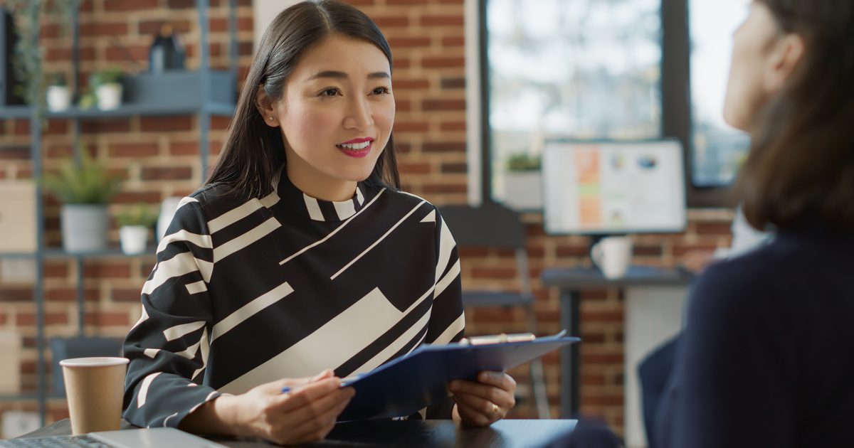 Fast candidate rejection shown as a recruiter interviewing a job candidate across a desk